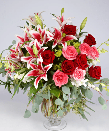 Lush and exquisite, this arrangement of lilies, roses, eucalyptus, and more is sure to turn heads. Perfect for celebrating an anniversary, birthday, or milestone event.
