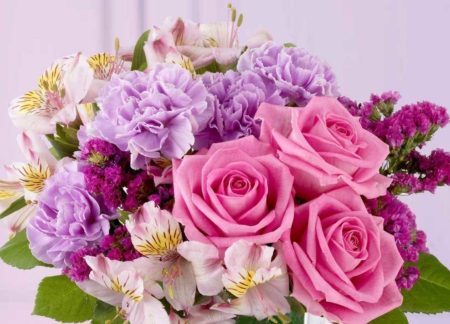 A glamorous bouquet of fresh flowers in delectable shades of raspberry, lavender and pink. Roses, alstromeria lilies among other in season florals are sure to delight any lucky recipient.