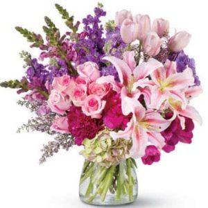 Nothing makes a grander impression than an enormous, gorgeous bouquet of fresh flowers. And this dramatic floral arrangement of roses, peonies, lilies, tulips and more – in radiant, blushing shades of pink and purple – is fit for royalty! It’s a remarkable gift that will be remembered forever.