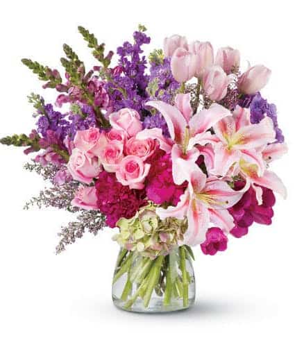 Nothing makes a grander impression than an enormous, gorgeous bouquet of fresh flowers. And this dramatic floral arrangement of roses, peonies, lilies, tulips and more – in radiant, blushing shades of pink and purple – is fit for royalty! It’s a remarkable gift that will be remembered forever.