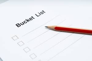 Bucket list on white paper with red pencil