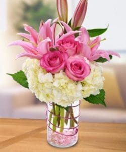 lovely design of white hydrangeas, elegant pink lilies, and Sweet Unique Roses